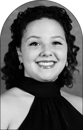 Black and white portrait of a smiling woman with curly hair, wearing a sleeveless halter top and rectangular earrings, posed against a plain background—an image that highlights expressive hair and modern design concepts.